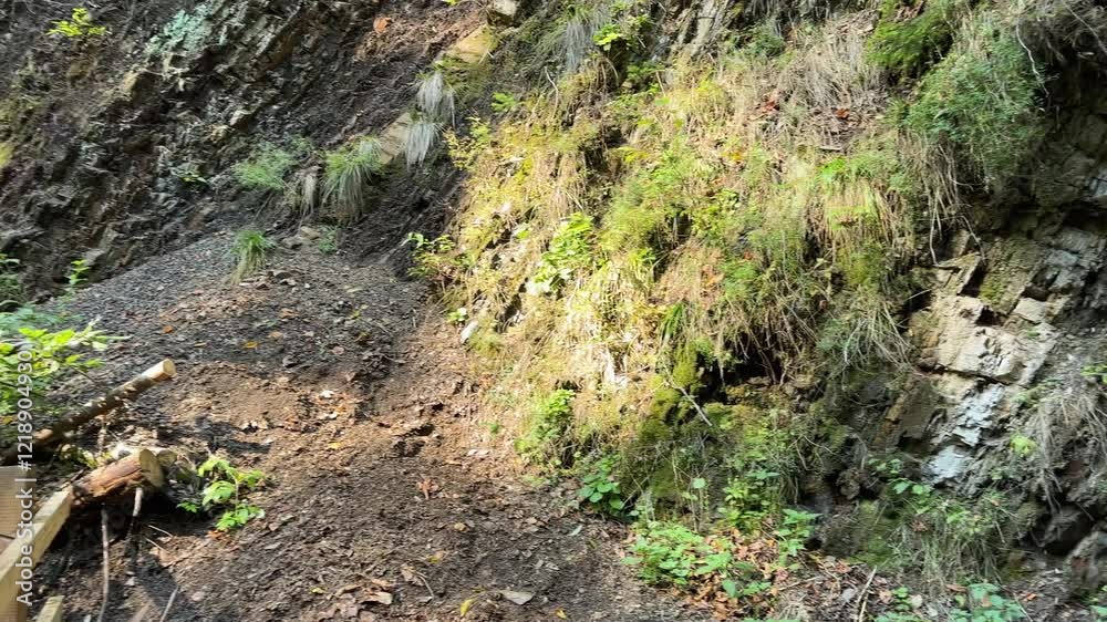 Waterfall on a mountain river on rocky slope in forest Waterfall on a mountain river on rocky slope in forest