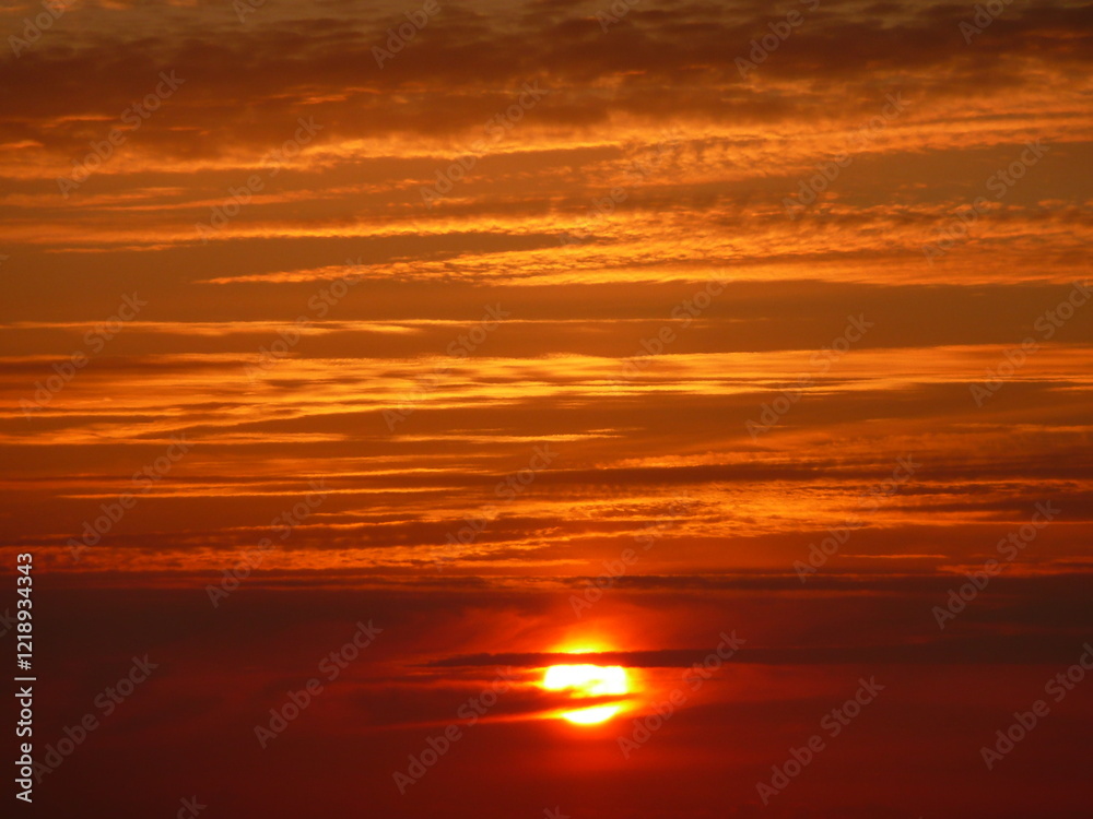 il sole al tramonto in un cielo rosso e arancione il sole al tramonto in un cielo rosso e arancione