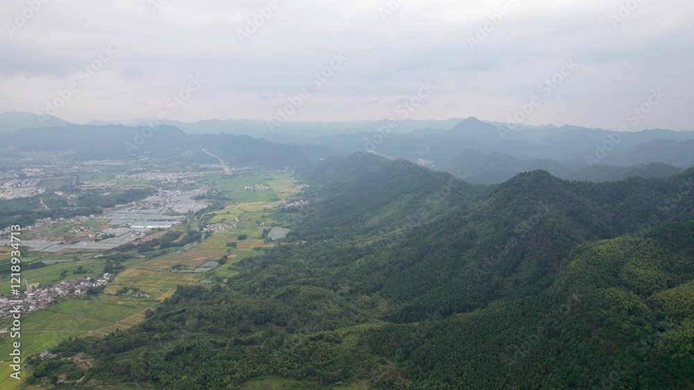 Drone view villages and farmlands among green mountains, high angel view rural landscape in autumn day, 4k real time footage b roll shot, Nanping village, Yixian, Anhui, China. Drone view villages and farmlands among green mountains, high angel view rural landscape in autumn day, 4k real time footage b roll shot, Nanping village, Yixian, Anhui, China.