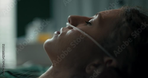Young patient wakes up and looks up from her hospital bed.