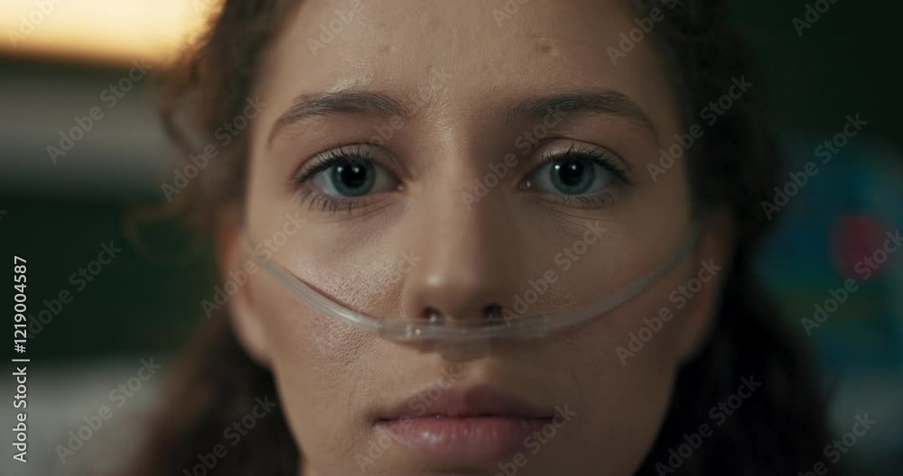 Brave young girl with an oxygen tube laughs, spreading positivity from her hospital bed.