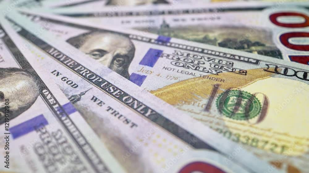 A large number of 100-dollar bills, the national currency of the United States, a close-up view from above, rotating clockwise.