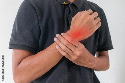 A man holding his sore or painful wrist