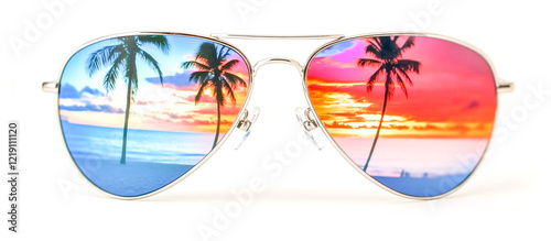 Fototapeta Naklejka Na Ścianę i Meble -  Gleaming silver aviator sunglasses reflecting the vibrant colors of an island sunset, with palm trees and sandy beaches in the background.