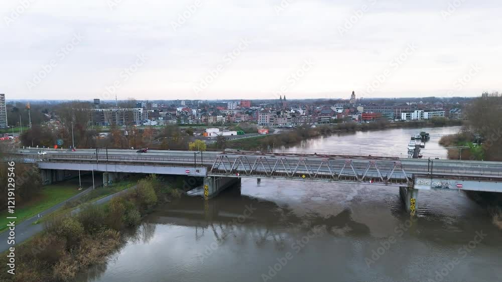 bridge cars crossing city dendermonde set against backdrop scheldt river town perspective transportation forward aerial drone shot belgium scenic view bridge cars crossing city dendermonde set against backdrop scheldt river town perspective transportation forward aerial drone shot belgium scenic view
