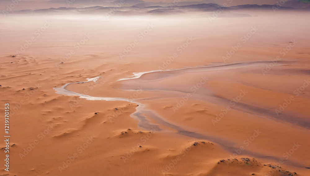 Desert Oasis: Aerial view of a winding waterway cutting through the vast expanse of the sandy desert, creating a striking contrast of textures and colors under a hazy sky. Desert Oasis: Aerial view of a winding waterway cutting through the vast expanse of the sandy desert, creating a striking contrast of textures and colors under a hazy sky.