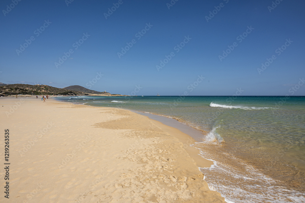 The beautiful beach of Su Giudeu in the south of Sardinia with transparent and turquoise water and a small island in front of the bay
