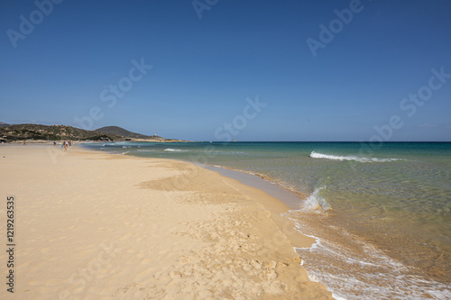 Obraz na płótnie The beautiful beach of Su Giudeu in the south of Sardinia with transparent and turquoise water and a small island in front of the bay w salonie