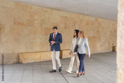 Businesspeople are walking and talking together in the city