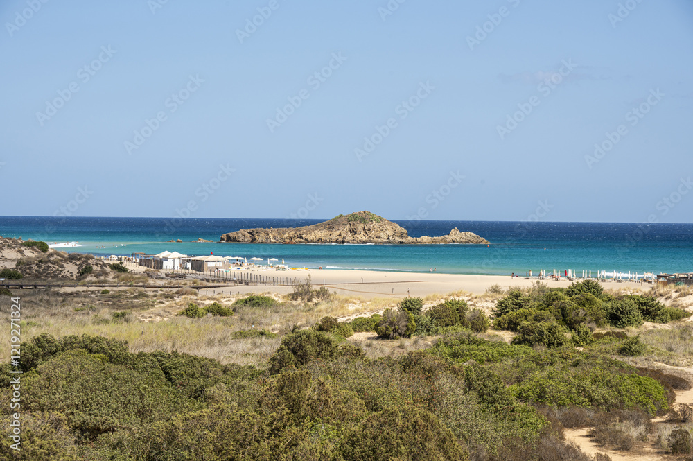 The beautiful beach of Su Giudeu in the south of Sardinia with transparent and turquoise water and a small island in front of the bay
