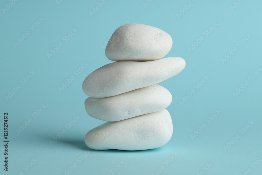 Stack of rocks on light blue background. Harmony and life balance Stack of rocks on light blue background. Harmony and life balance