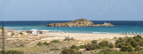 Obraz na płótnie The beautiful beach of Su Giudeu in the south of Sardinia with transparent and turquoise water and a small island in front of the bay w salonie