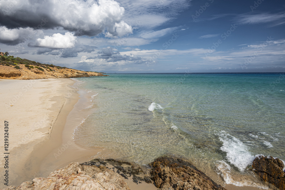 The beautiful beach of Pinus with fine sand and blue and turquoise water and storm clouds on the horizon