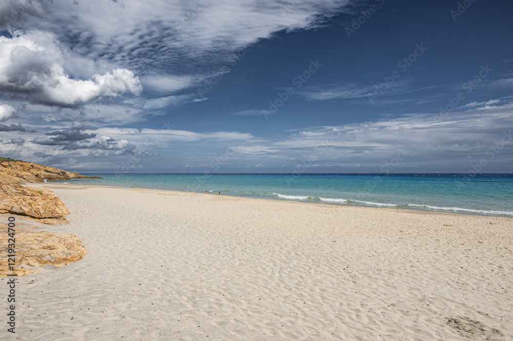 The beautiful beach of Pinus with fine sand and blue and turquoise water and storm clouds on the horizon