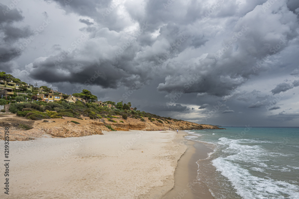 The beautiful beach of Pinus with fine sand and blue and turquoise water and storm clouds on the horizon