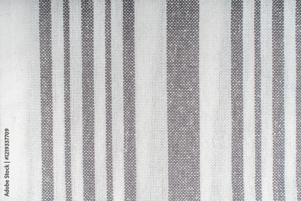Fototapeta premium Background with white gray stripe fabric texture. A strict and laconic background with stripes of different widths.