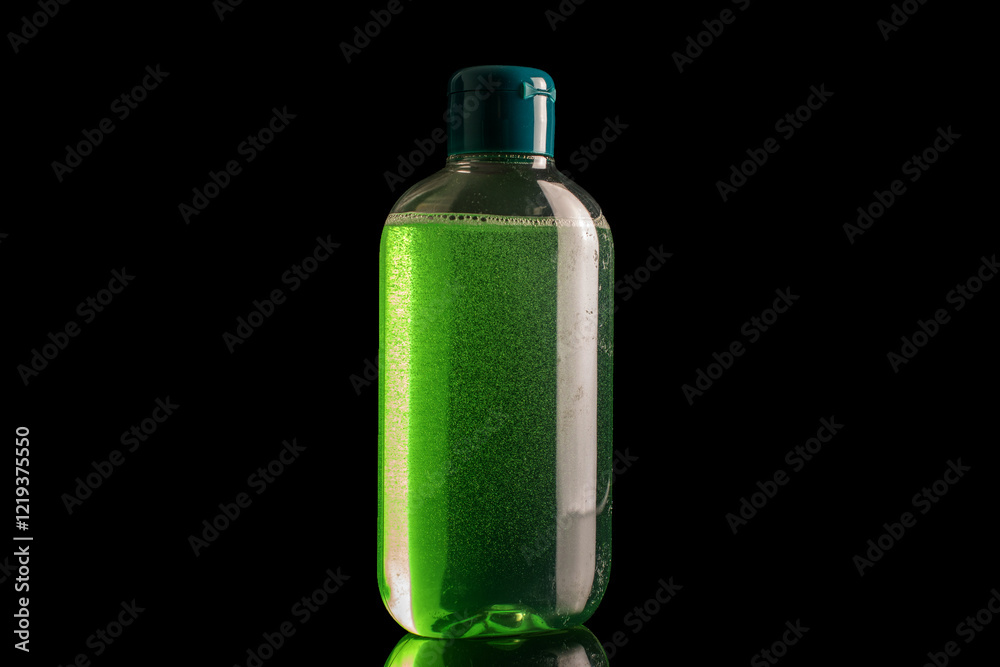 One plastic shampoo package, macro, isolated on black background. One plastic shampoo package, macro, isolated on black background.