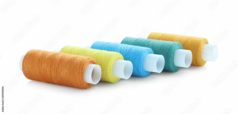 Spools of bright sewing threads isolated on white Spools of bright sewing threads isolated on white