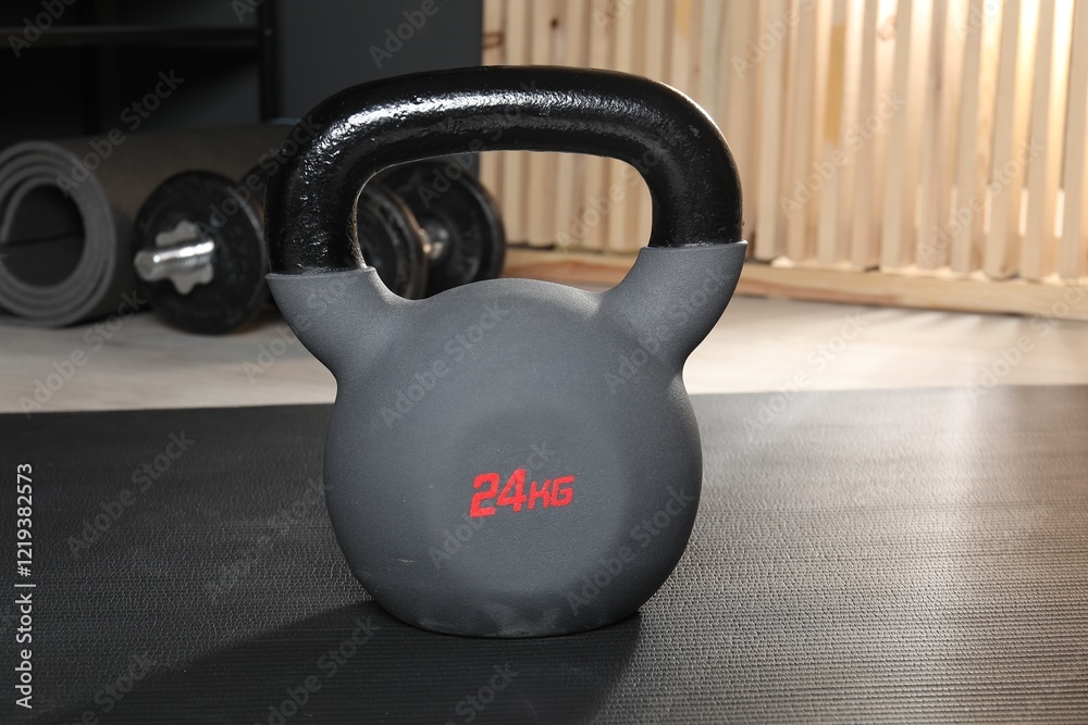 Fototapeta premium One kettlebell on mat in gym, closeup