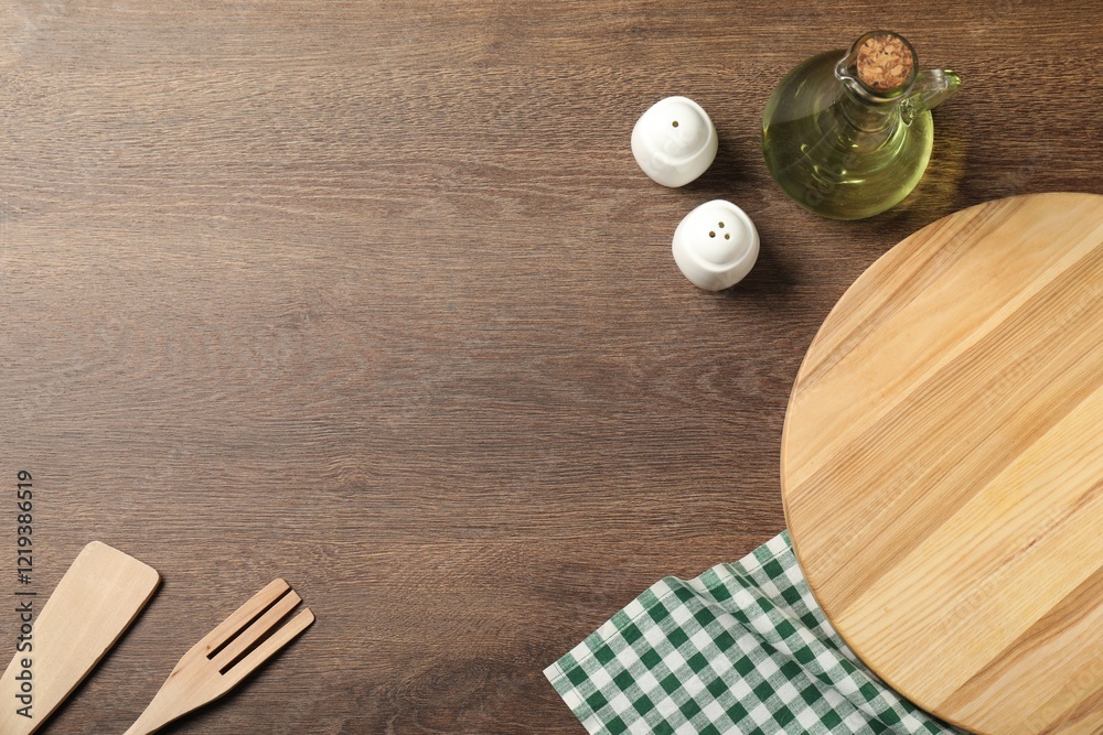 Checkered tablecloth, cooking utensils, oil and spices on wooden table, flat lay. Space for text Checkered tablecloth, cooking utensils, oil and spices on wooden table, flat lay. Space for text
