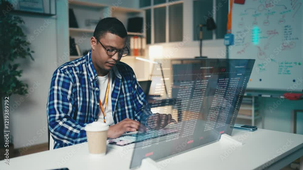 African American programmer develops software on a futuristic computer screen