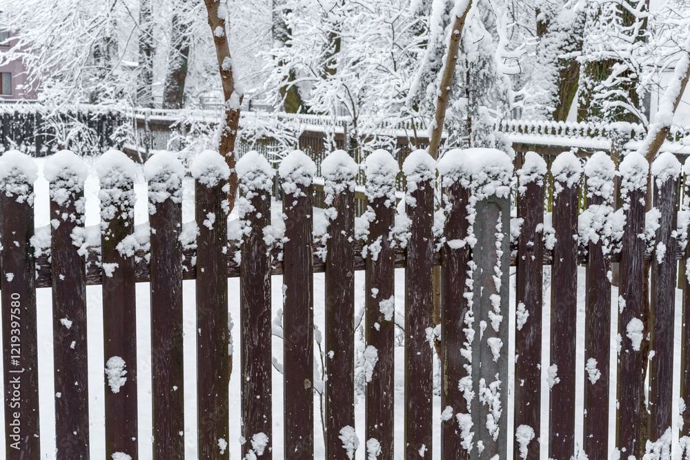 A snowstorm with an old wooden fence and a yard A snowstorm with an old wooden fence and a yard