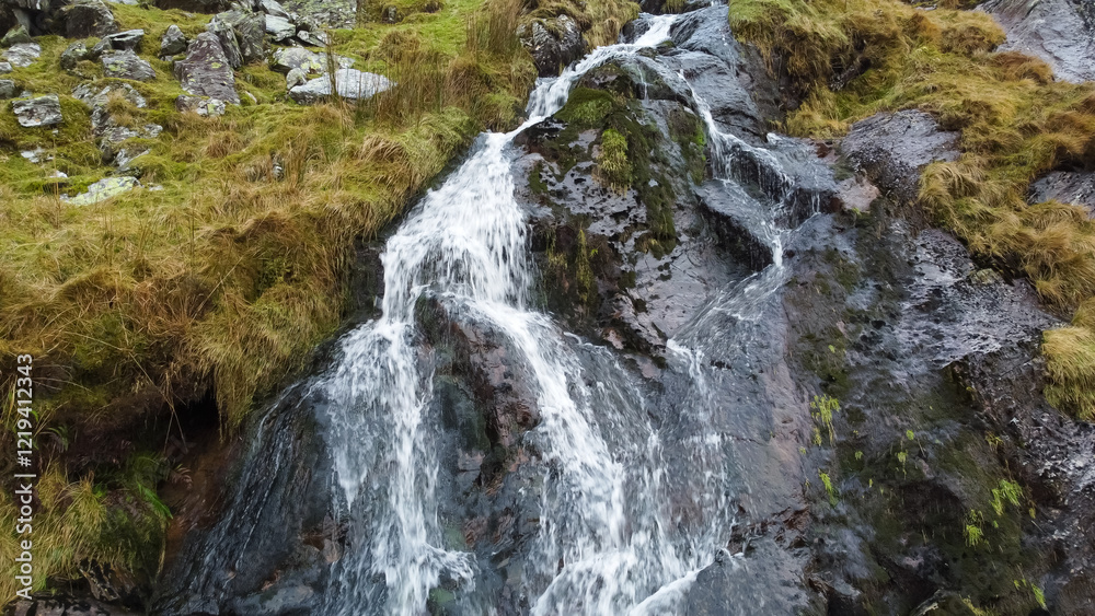 Aerial view of small waterfall cascading down Moel Druman mountain in Moelwyn mountains Aerial view of small waterfall cascading down Moel Druman mountain in Moelwyn mountains
