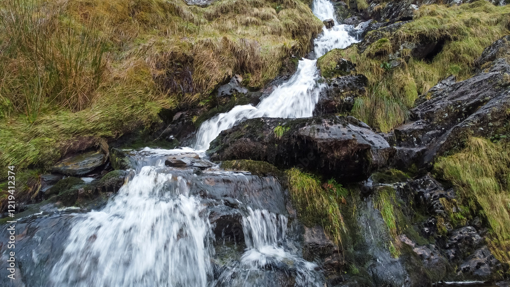 Aerial view of small waterfall cascading down Moel Druman mountain in Moelwyn mountains Aerial view of small waterfall cascading down Moel Druman mountain in Moelwyn mountains