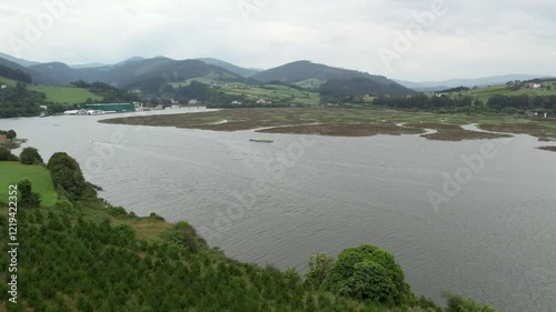 Aerial view of a small motor boat sailing in the Ribadeo estuary in Galicia, Spain - 160
 photo