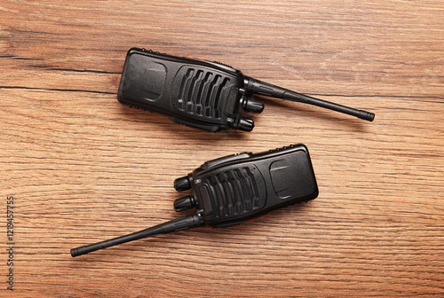 Walkie talkies on wooden table, top view photo