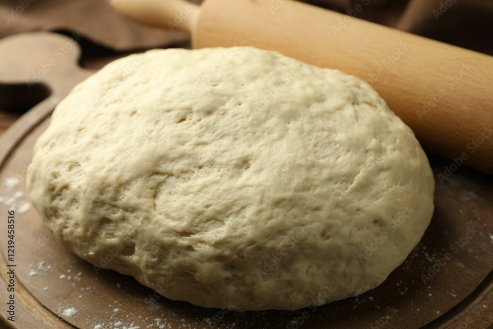 Fresh dough and rolling pin on table, closeup Fresh dough and rolling pin on table, closeup