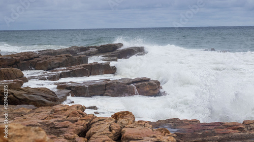 Waves crashing on rocks on the South Coast of South Africa in Margate, Uvongu.  photo