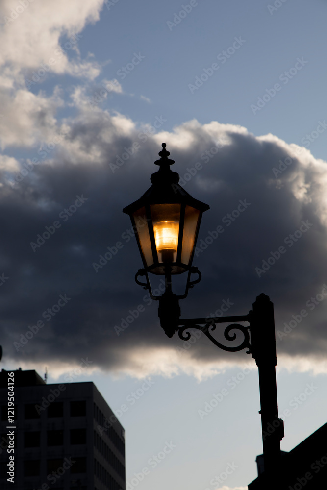 Street light in front of a Cloud Street light in front of a Cloud