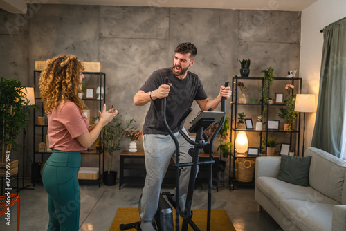 adult man exercise and use modern elliptical machine at home