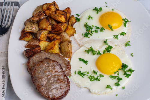 fried eggs top with parsley  with sausage patty photo