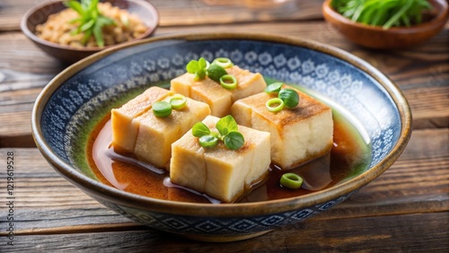 Savoring agedashi tofu in dashi broth at a traditional japanese eatery food photography cozy atmosphere culinary delight photo