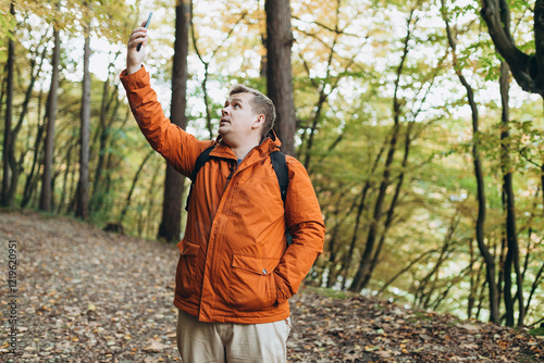 Obraz na płótnie Sad angry blonde man got lost and could not find an internet connection on phone while hiking alone in the forest. Road trip, transport, travel, technology and people concept. High quality photo w salonie