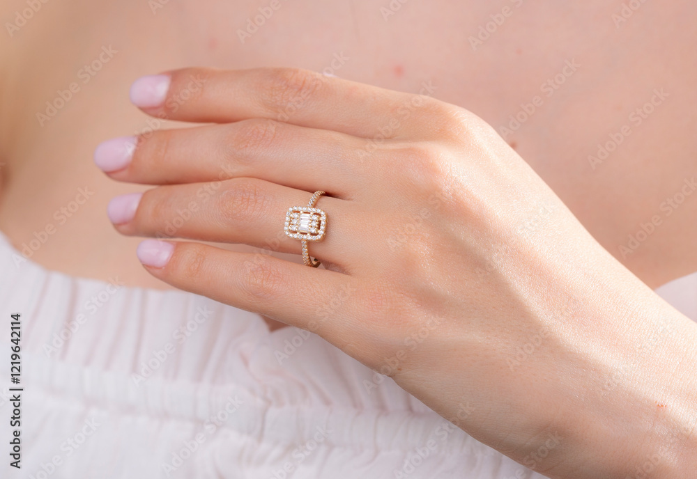Gold baguette ring on female model finger Gold baguette ring on female model finger