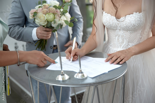 Wedding ceremony signing with bride, groom, and official witness at table