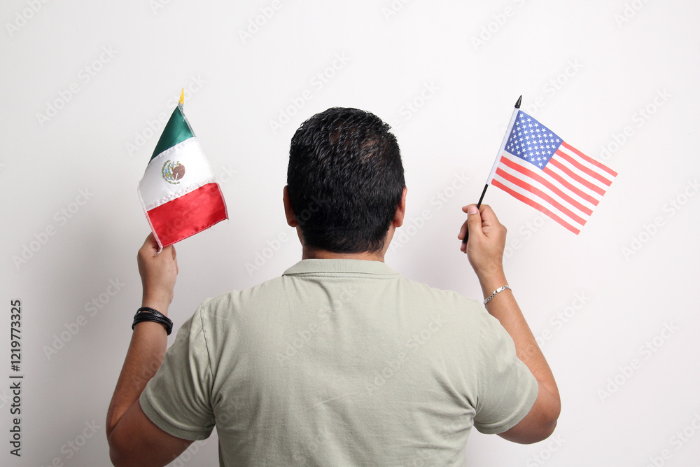 40-year-old dark-skinned Latino man holds the flags of Mexico and the United States in his hands thoughtfully deciding where to live 40-year-old dark-skinned Latino man holds the flags of Mexico and the United States in his hands thoughtfully deciding where to live