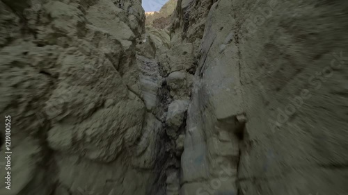 This 4K UHD footage captures a scenic hike through a narrow slot canyon in Death Valley National Park, California. The dramatic desert walls make it a popular adventure for hikers and nature enthusias