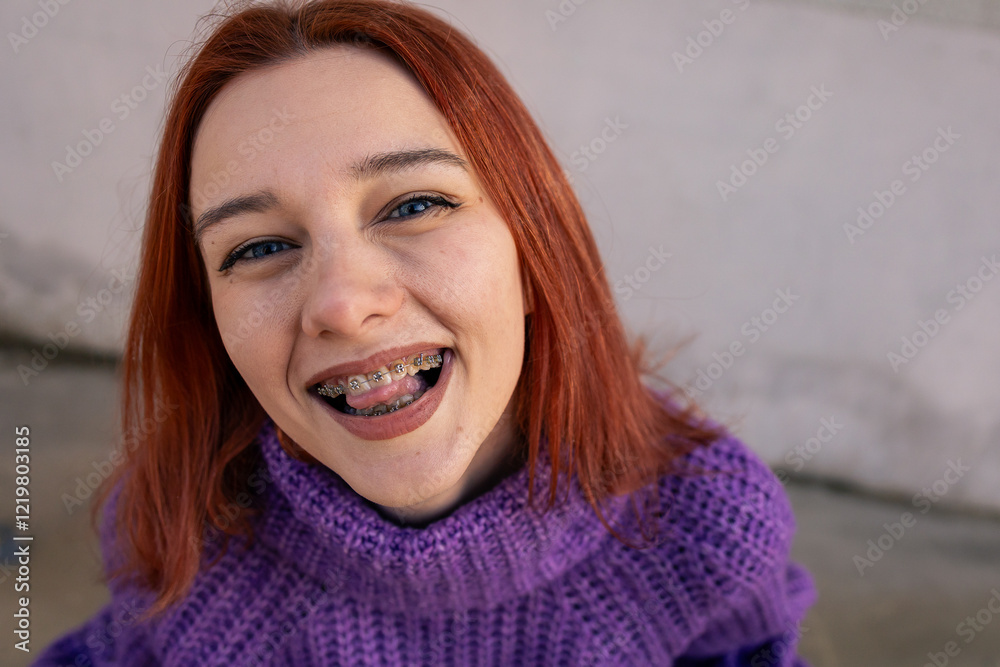 Smiling Redhead Girl with Braces Wearing a Purple Knitted Sweater Smiling Redhead Girl with Braces Wearing a Purple Knitted Sweater
