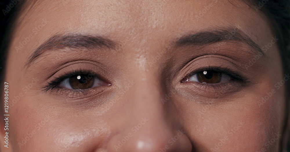 Fototapeta premium Delightful portrait video capturing a girl looking directly at the camera, playfully blinking, and breaking into laughter.