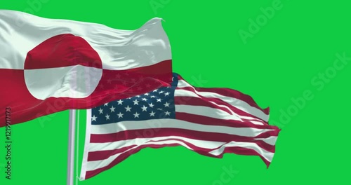 Flags of Greenland and the US waving isolated on green background photo