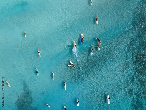 Drone Aerial View of Surfers Riding Waves in Hawaii Sea with Surfboards in the Blue transparent Ocean 