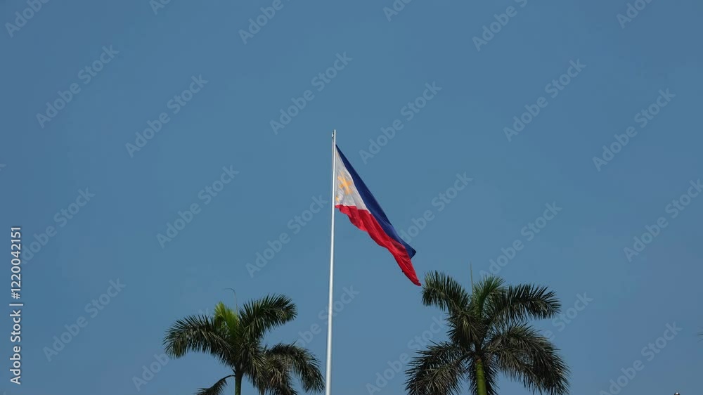 Philippine flag waving in the wind against a blue sky background. 4K ...