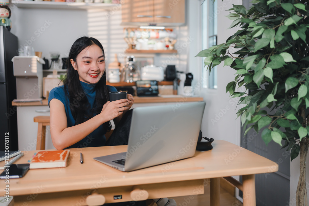 woman smiling while holding cup and working on laptop in cozy home office setting woman smiling while holding cup and working on laptop in cozy home office setting