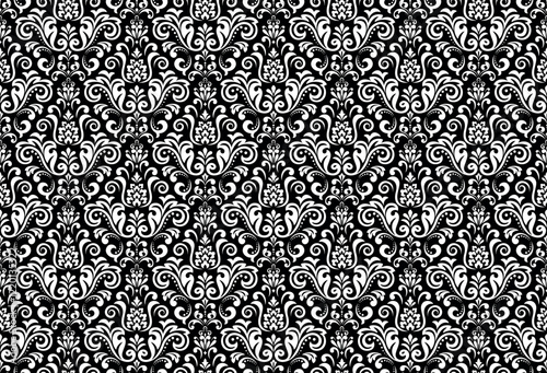Wallpaper in the style of Baroque. Seamless vector background. White and black floral ornament. Graphic pattern for fabric, wallpaper, packaging. Ornate Damask flower ornament.