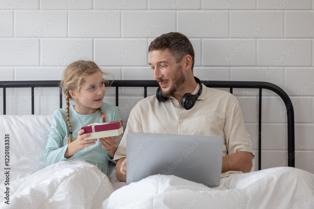 Obraz premium Father and daughter enjoy a joyful morning together as she surprises him with a gift in their cozy bedroom