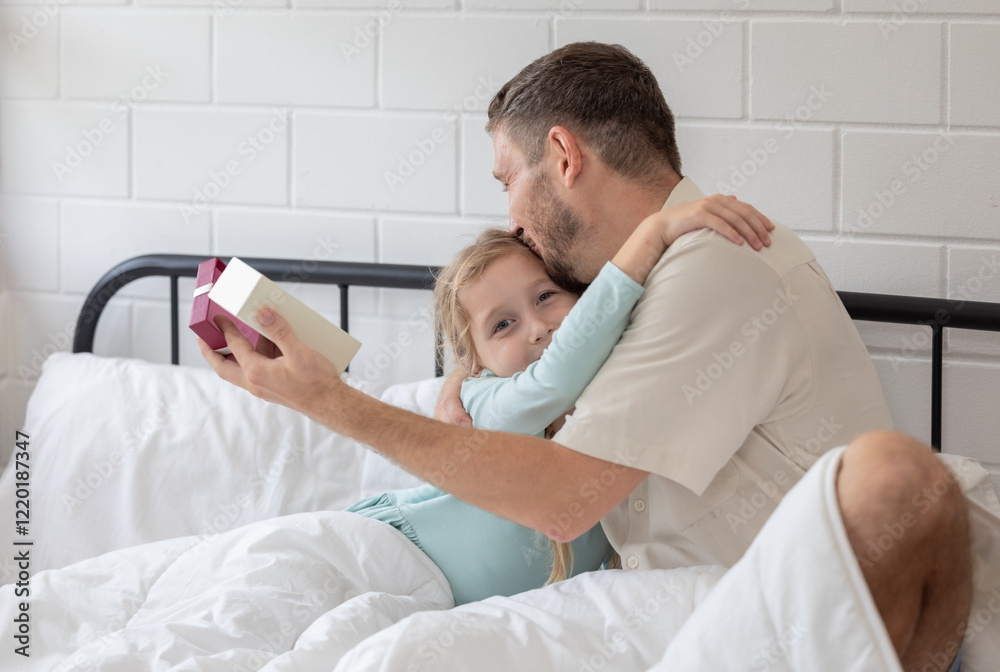 Fototapeta premium Father and daughter enjoy a joyful morning together as she surprises him with a gift in their cozy bedroom
